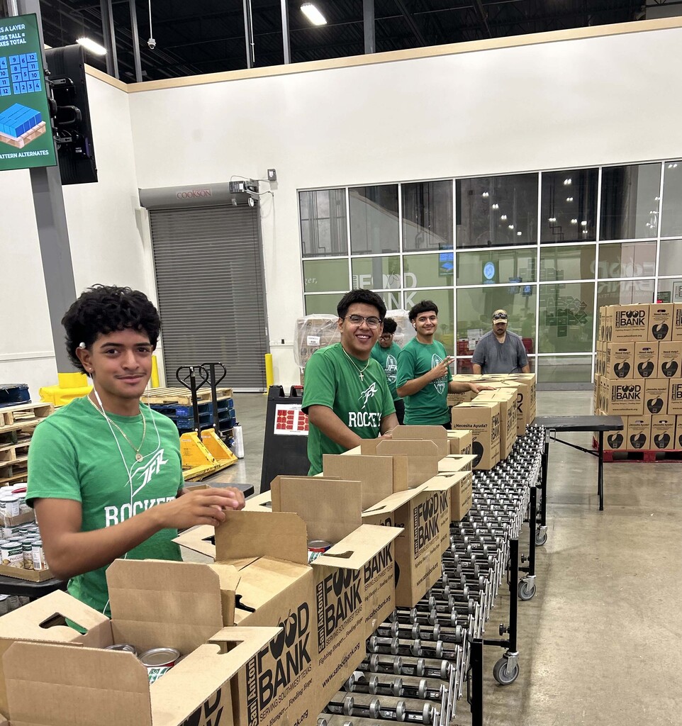 JFK Athletes sorting boxes of food at the Food Bank