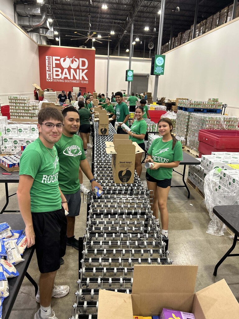 JFK Athletes sorting boxes of food at the Food Bank