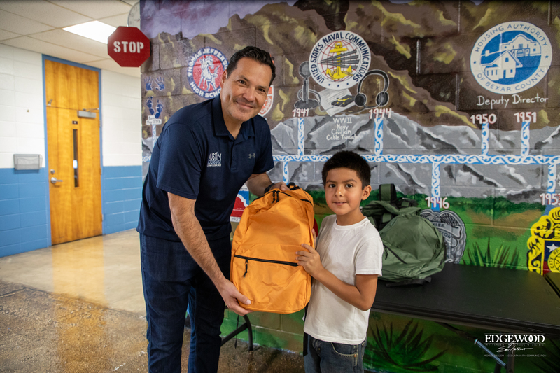 Commissioner Rodriguez presents new backpacks to student