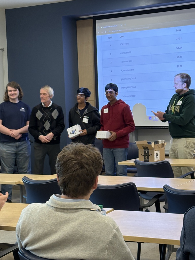 2 students being presented with their awards at Hawk Hack competition