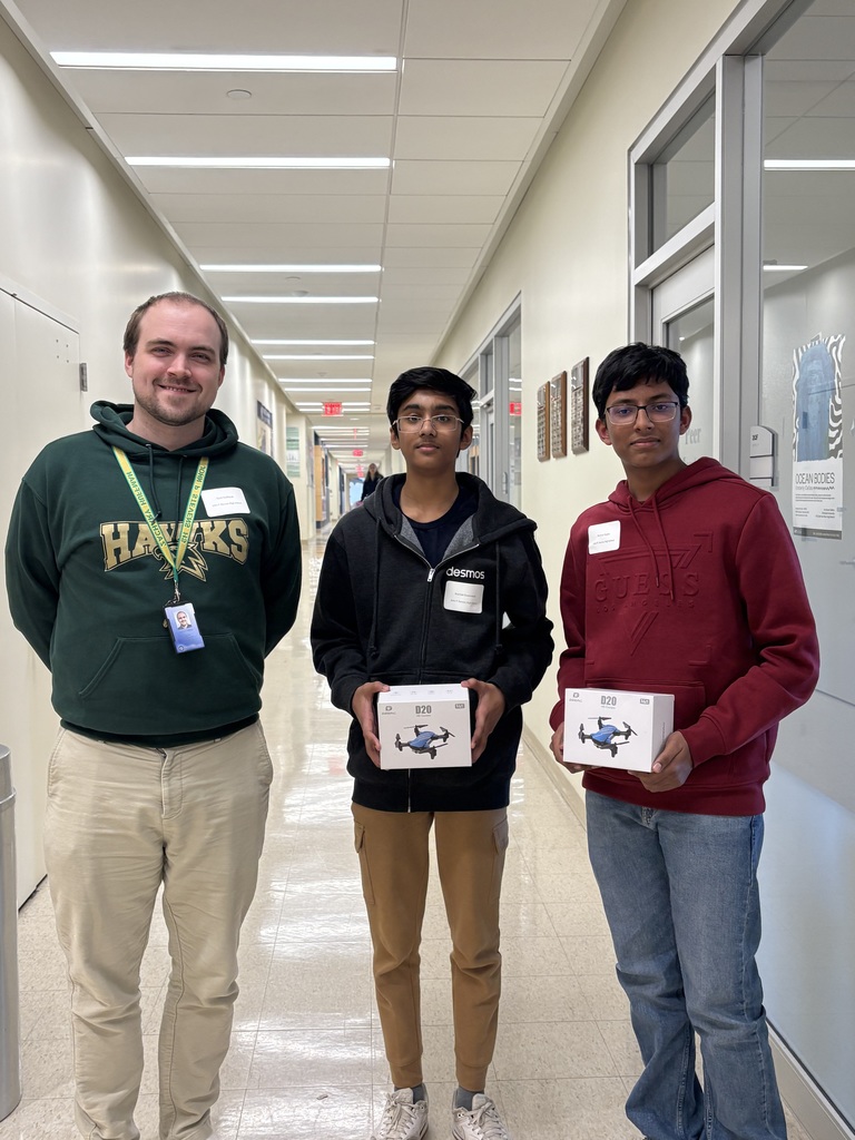 teacher and 2 student winners with drones at Hawk Hack competition