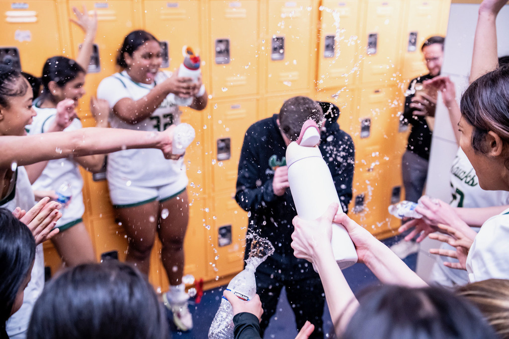Girls basketball celebrating win in locker room