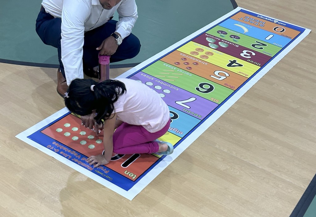 Child playing on math rug