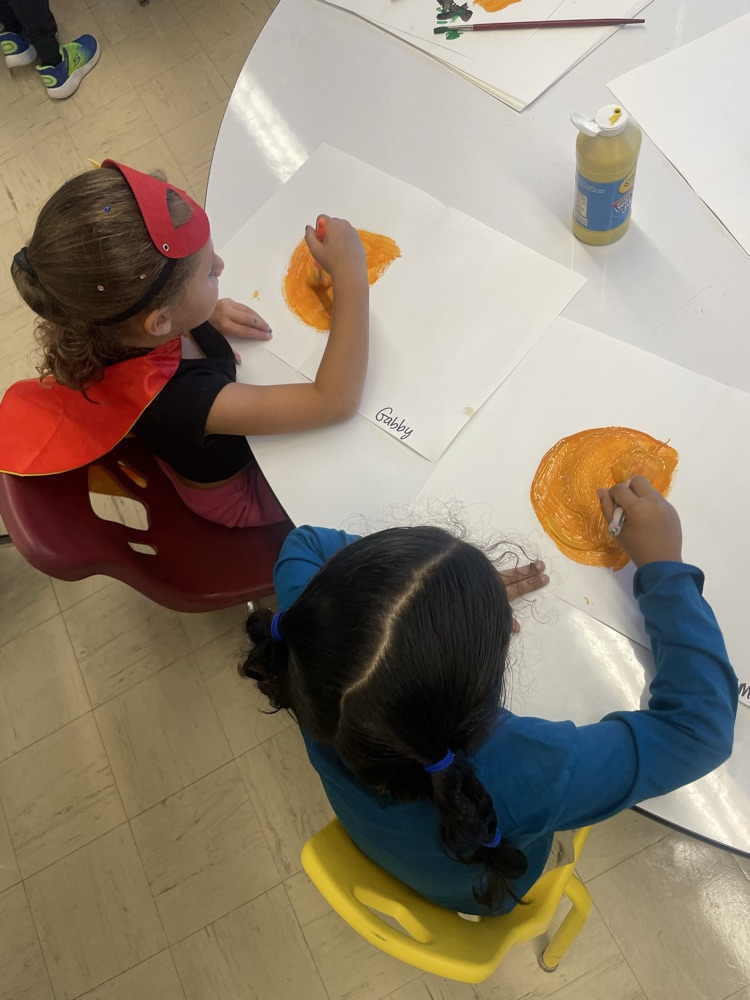 students painting their pumpkins