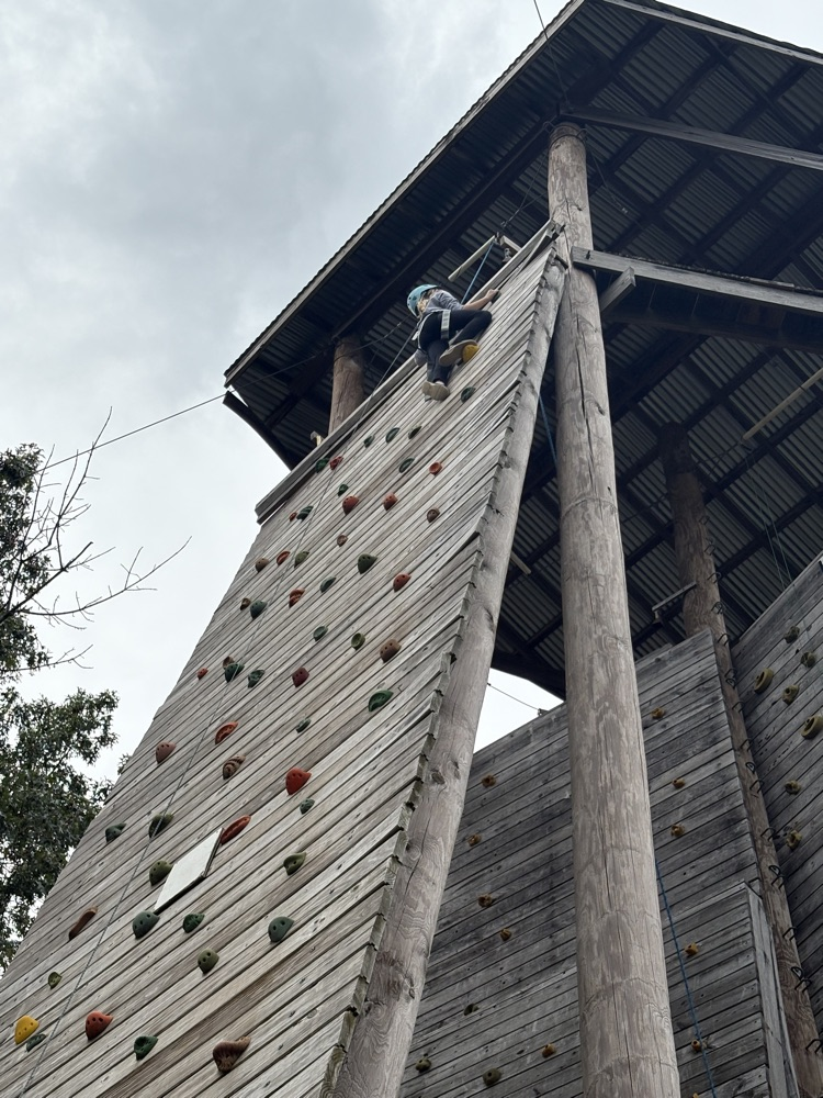 student on the climbing wall