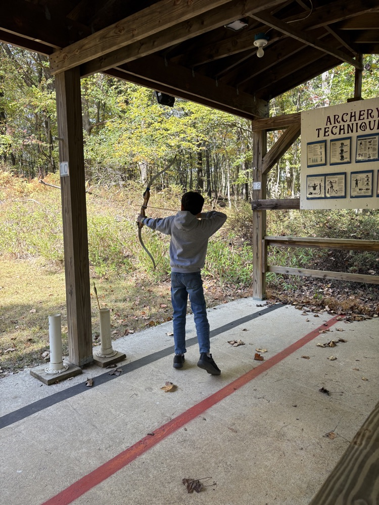 student practicing archery
