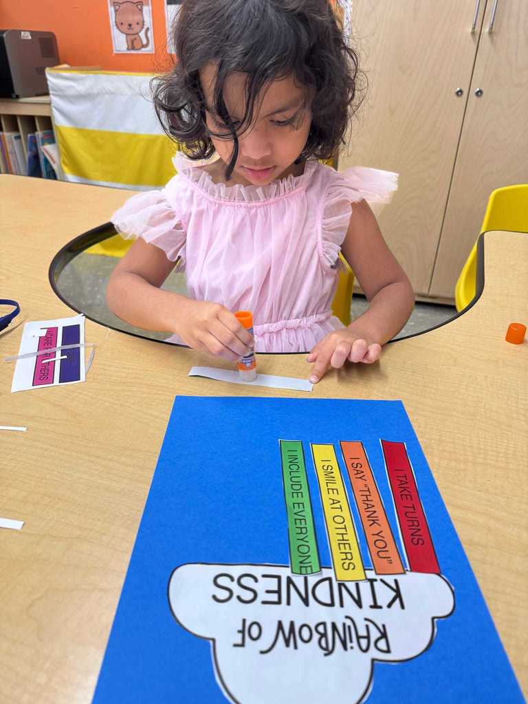 Young preschooler making a kindness rainbow