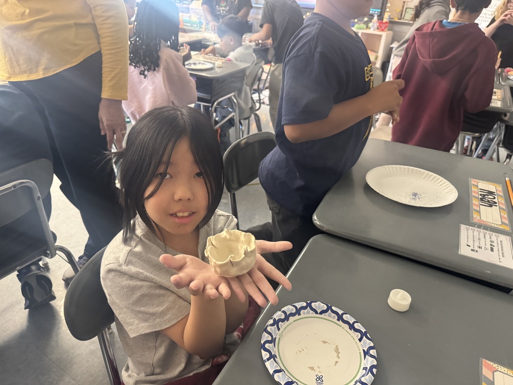 Students making diyas