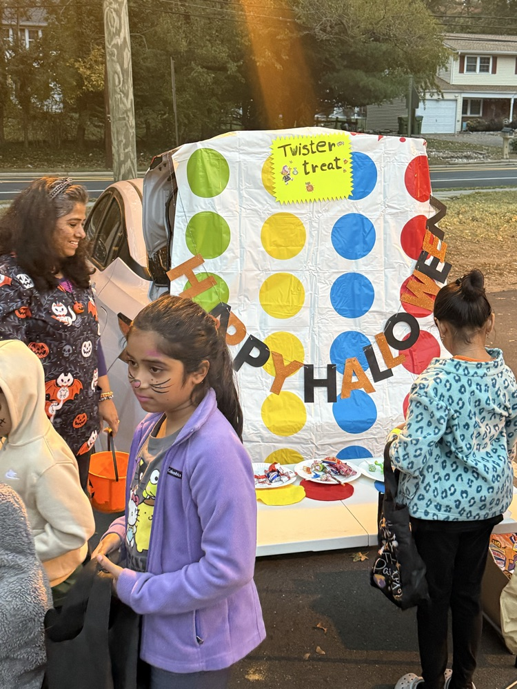 handing out candy while children trick or treat