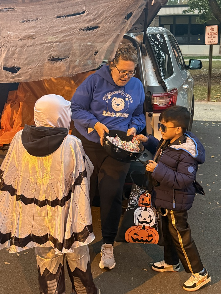 handing out candy while children trick or treat