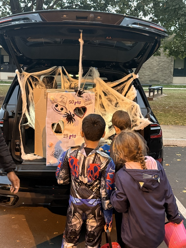 handing out candy while children trick or treat