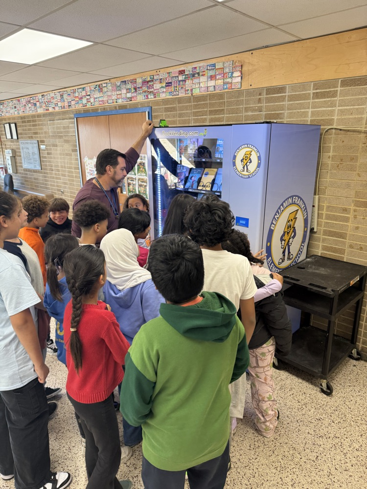 students choosing books from the vending machine