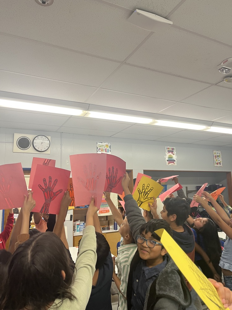 students holding hand skeletons