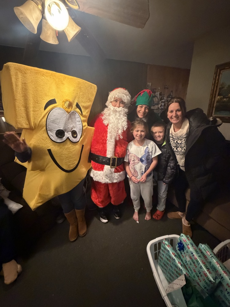 Santa, Jingles and Benny delivering presents with Dr. Bevere and Mr. D