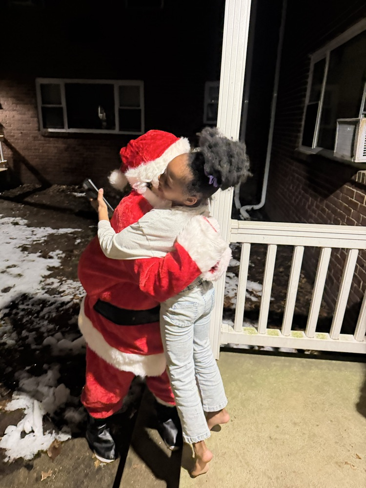 Santa, Jingles and Benny delivering presents with Dr. Bevere and Mr. D