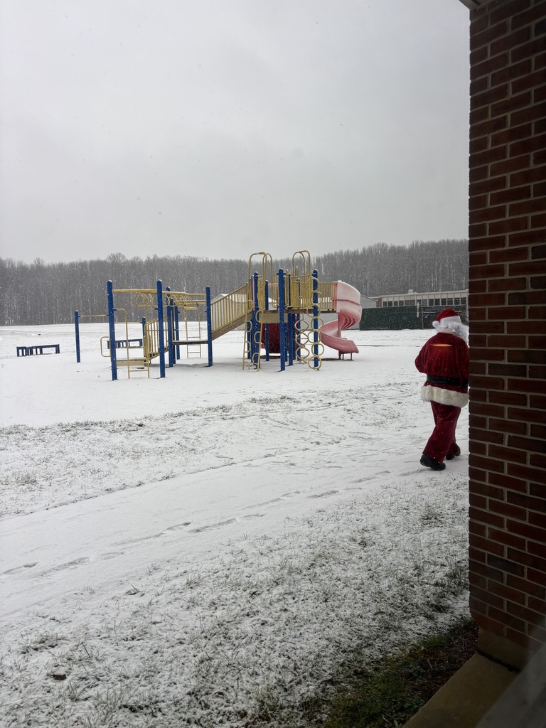 A snowy playground with Santa walking by