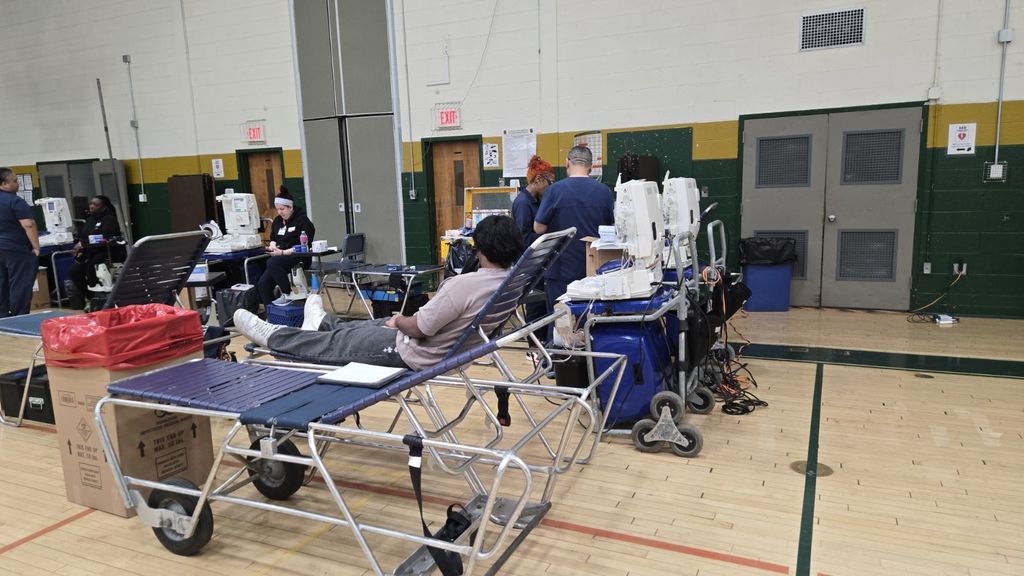 students donating blood in the gym