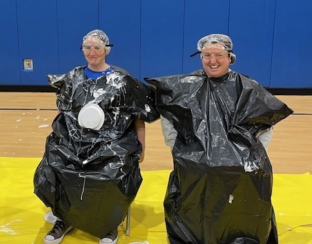 Principal and vice principal getting pie in face