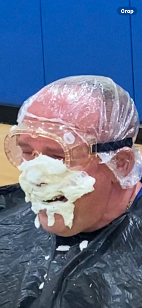 Security guard with pie on face