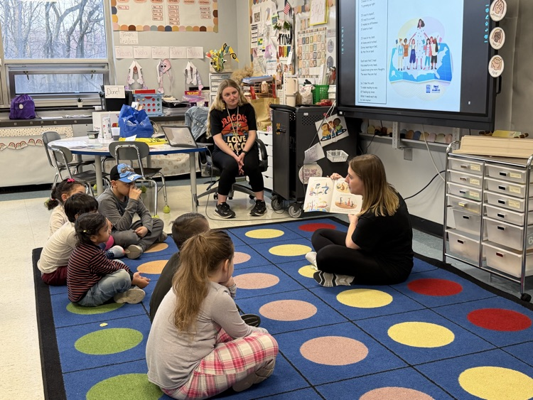 teachers reading book to students