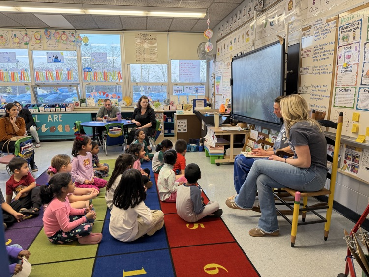 teachers reading book to students