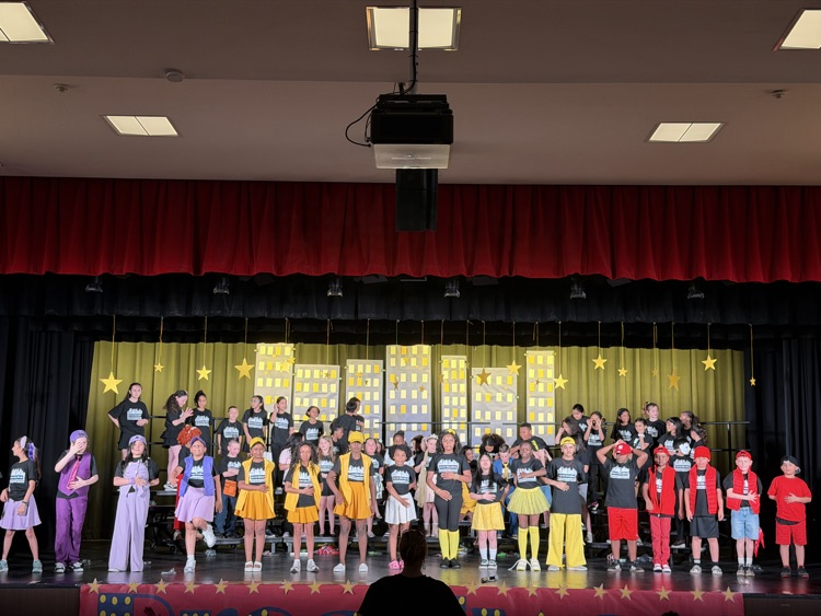 students on stage during performance 