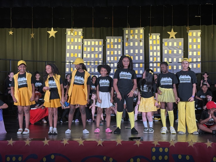 students on stage during performance 