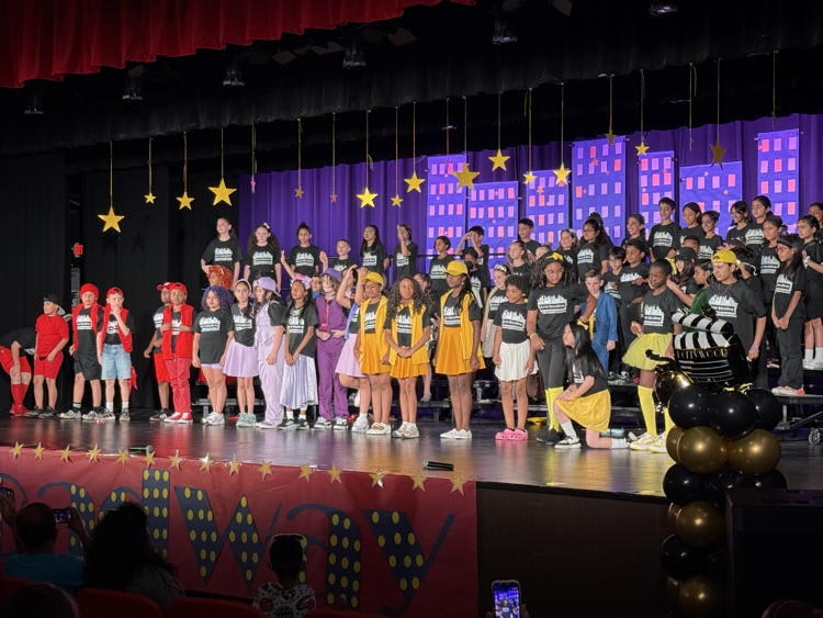 students on stage during performance 