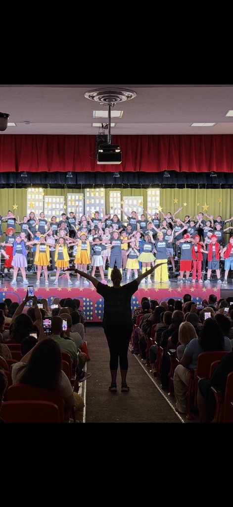students on stage during performance 