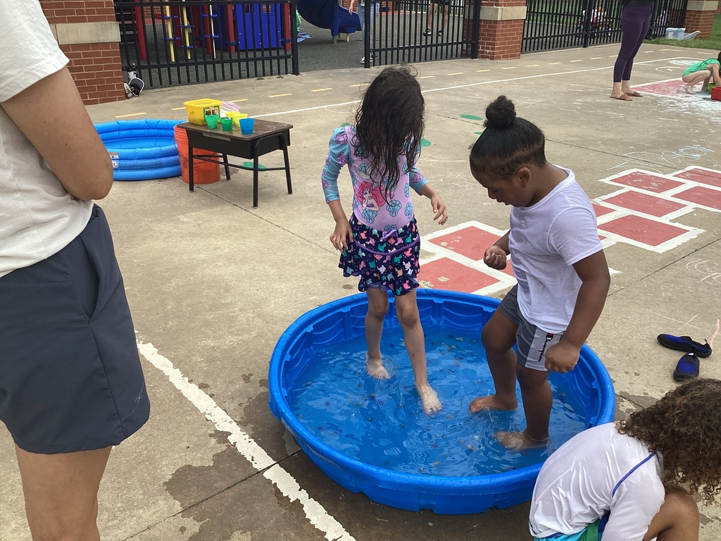 Children picking up marbles with their toes