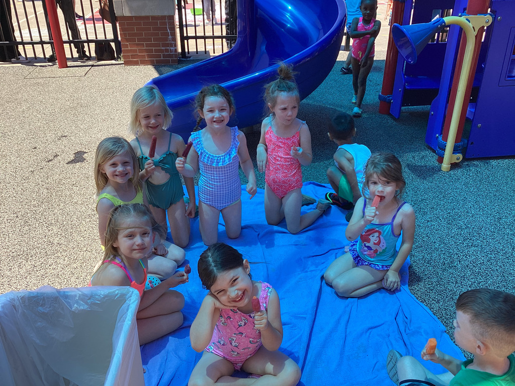 Students enjoying a popsicle in the shade