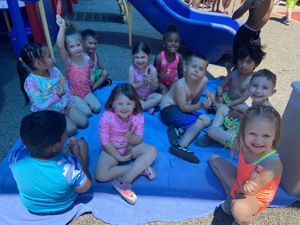 Students enjoying a popsicle in the shade 