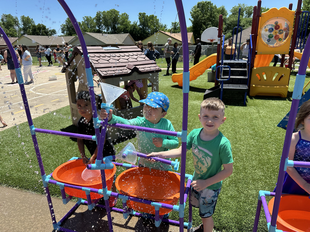 Students playing in water tubs