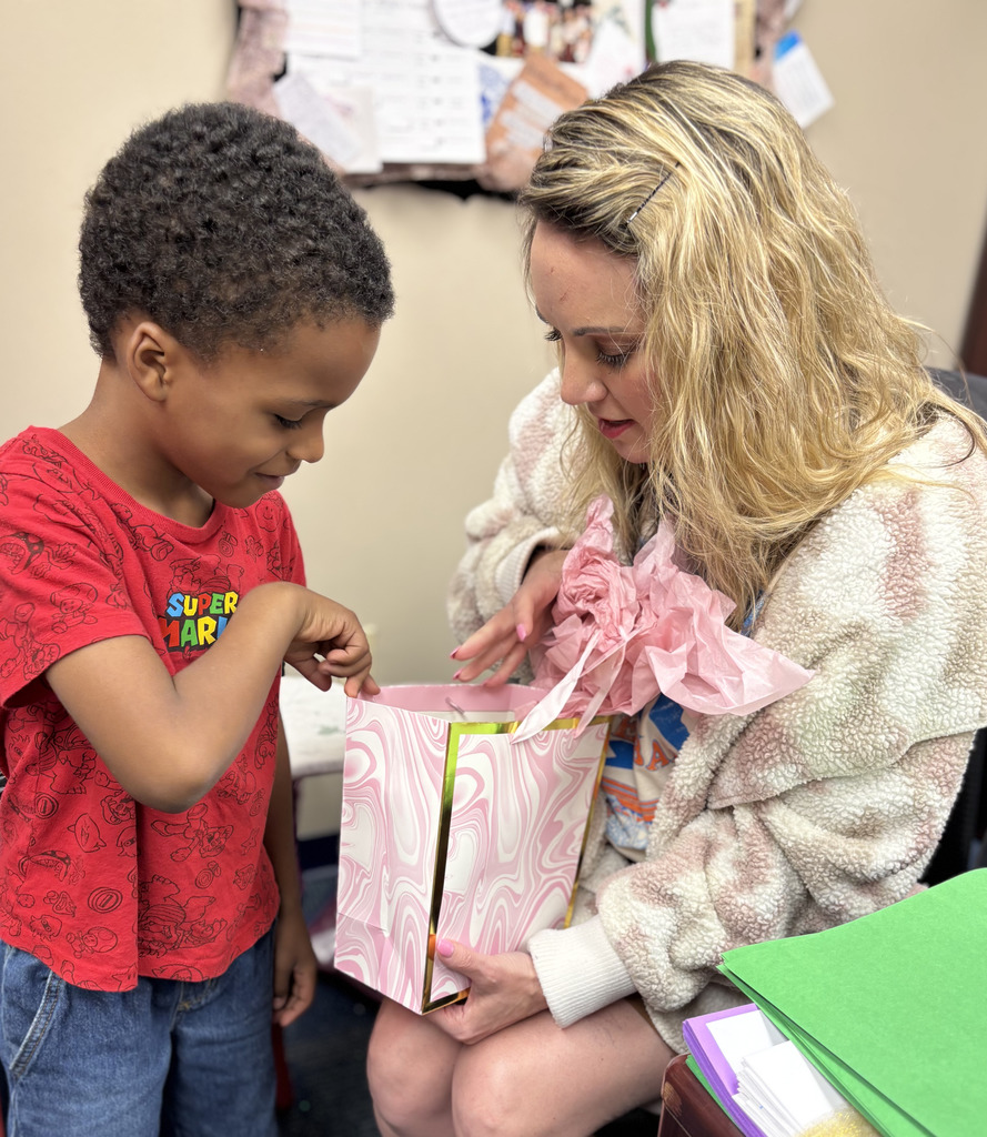 kinder student showing mrs williams her gift 