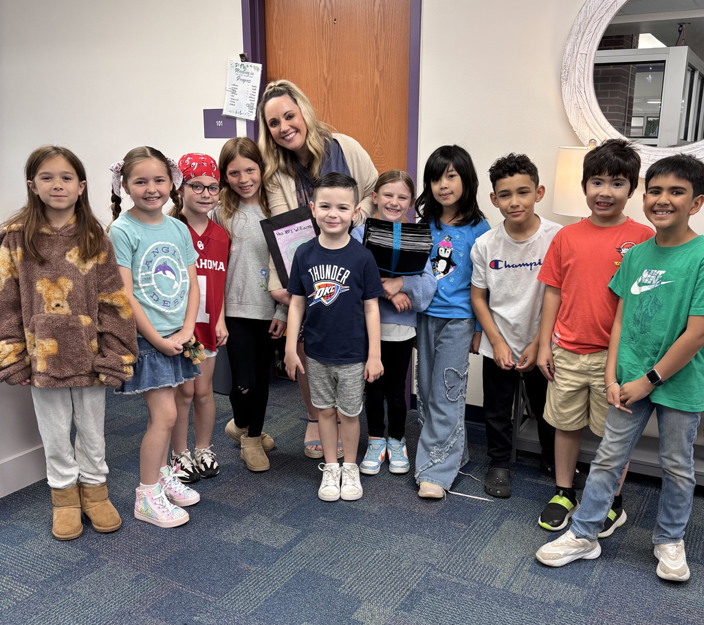 second grade students giving  mrs. williams goodies