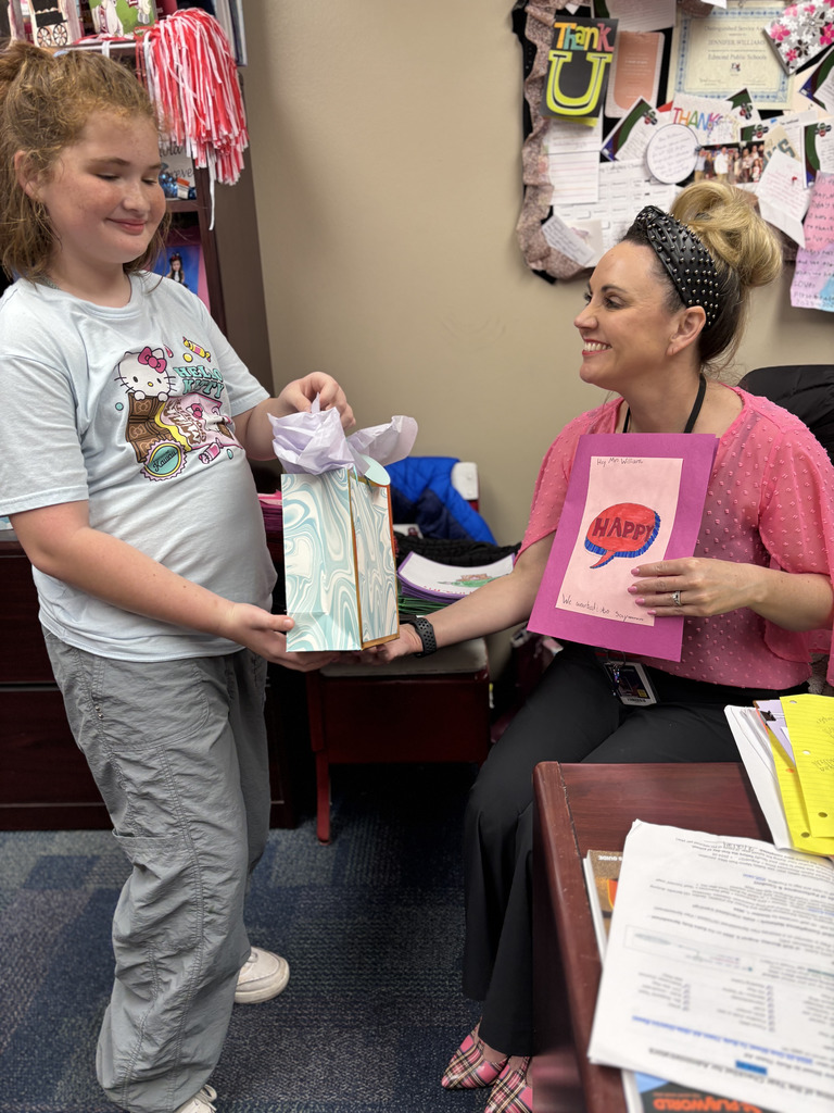 fourth grade student gifting mrs williams some goodies 