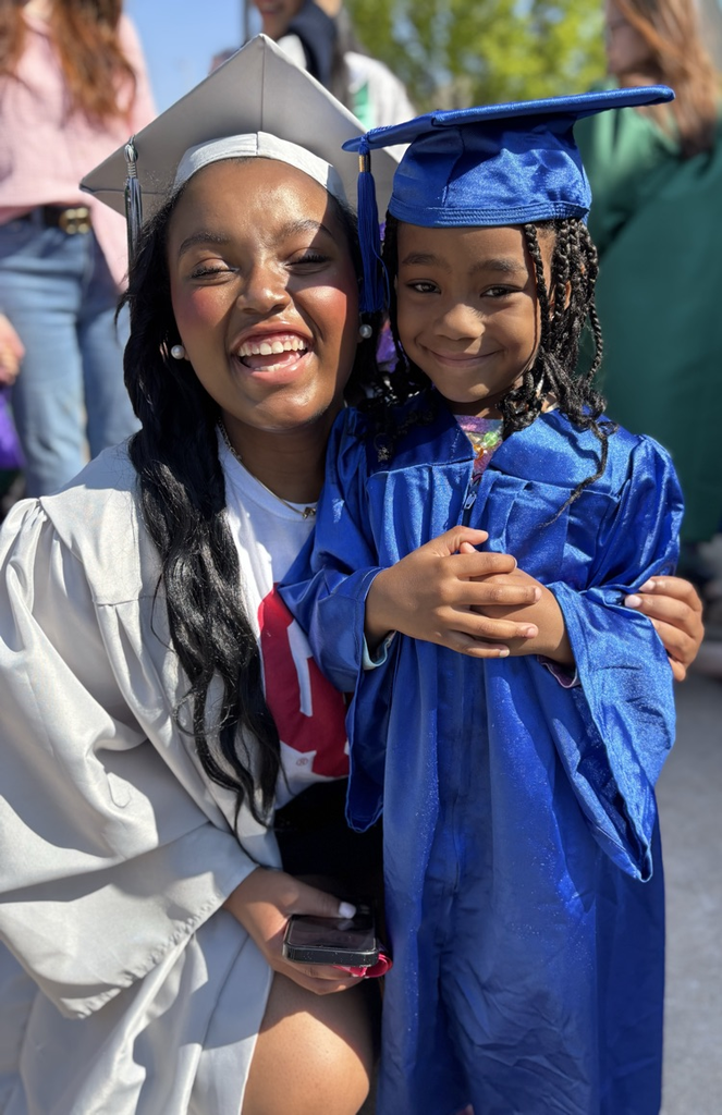 high school senior and pre-k graduate posing together 