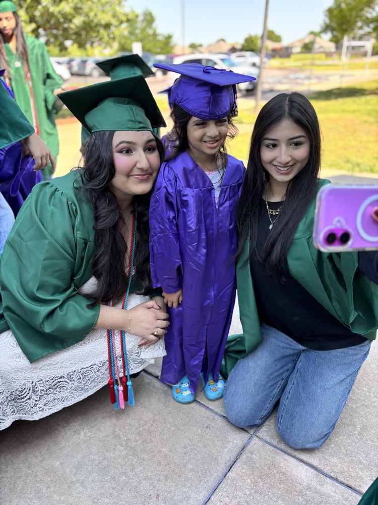 high school senior and pre-k graduate posing together 