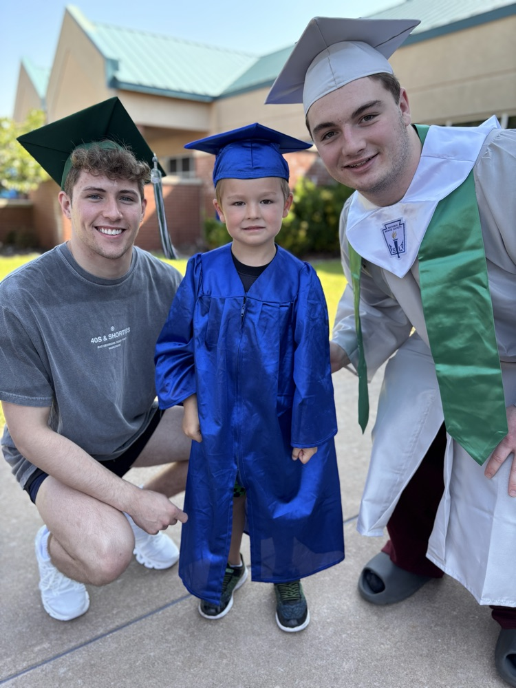 high school senior and pre-k graduate posing together 