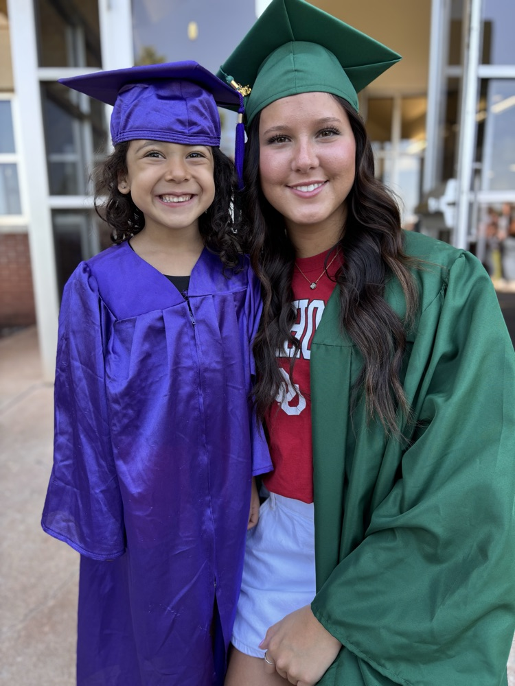 high school senior and pre-k graduate posing together 