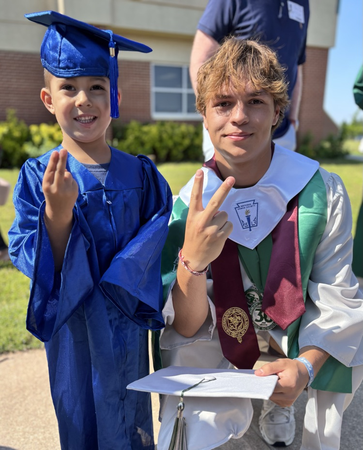 high school senior and pre-k graduate posing together 
