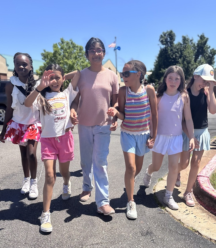 fifth grade girls walking in graduation clap out 