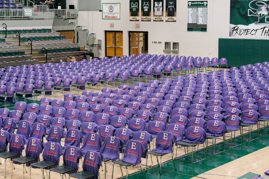 shirts set up on chairs in a gym