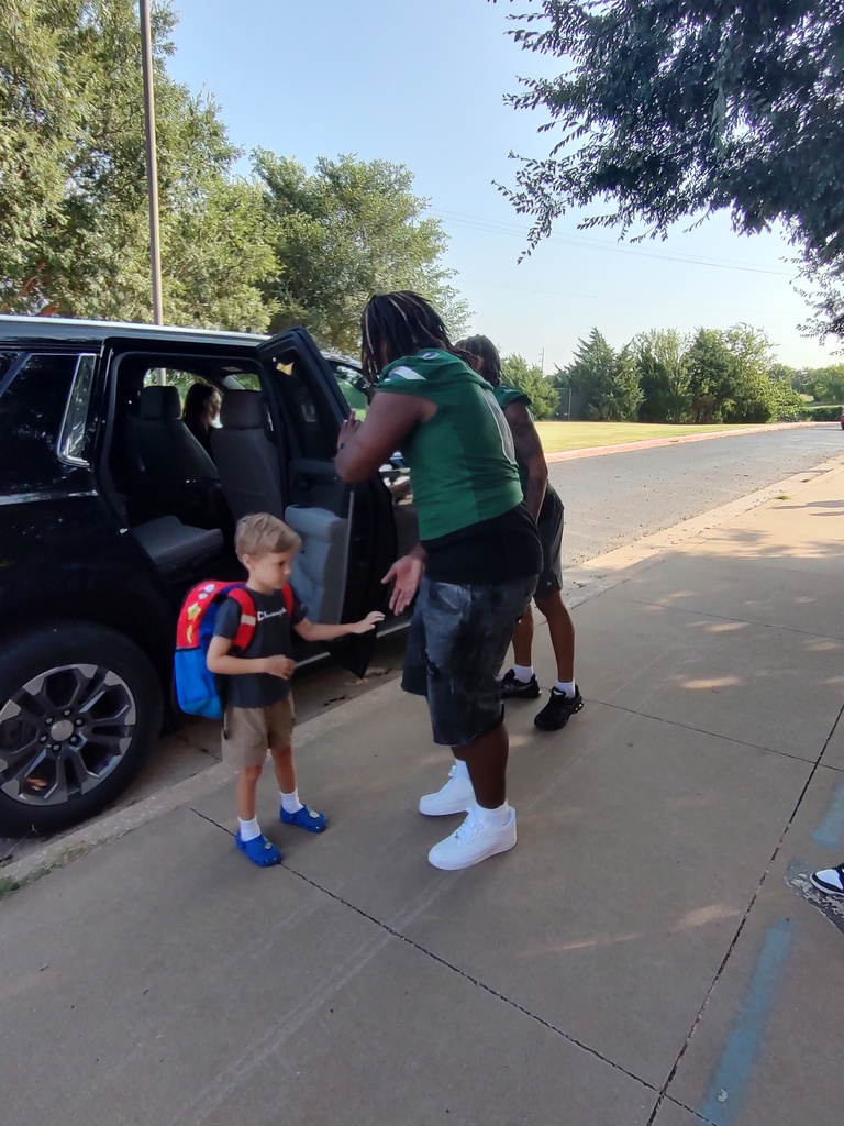 Students welcomed to the building by football players