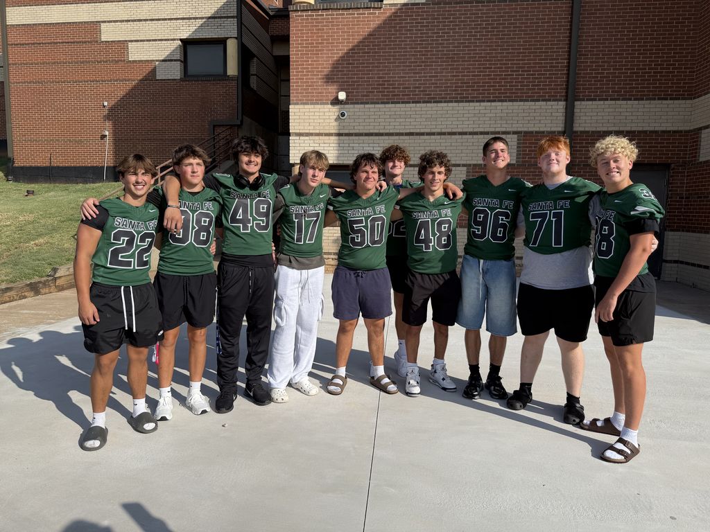 Students welcomed to the building by football players
