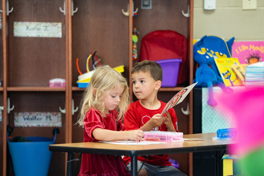 pre schooler working on a craft at their table