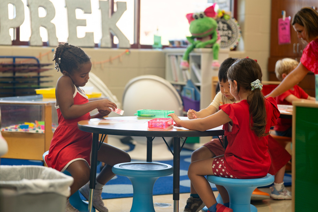 pre schooles working on a craft at their table