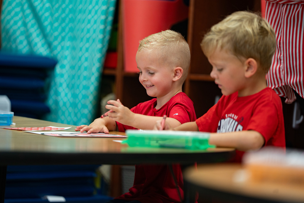 pre schooler working on a craft at their table