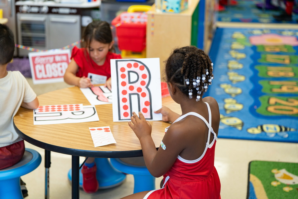pre schooler working on a craft at their table