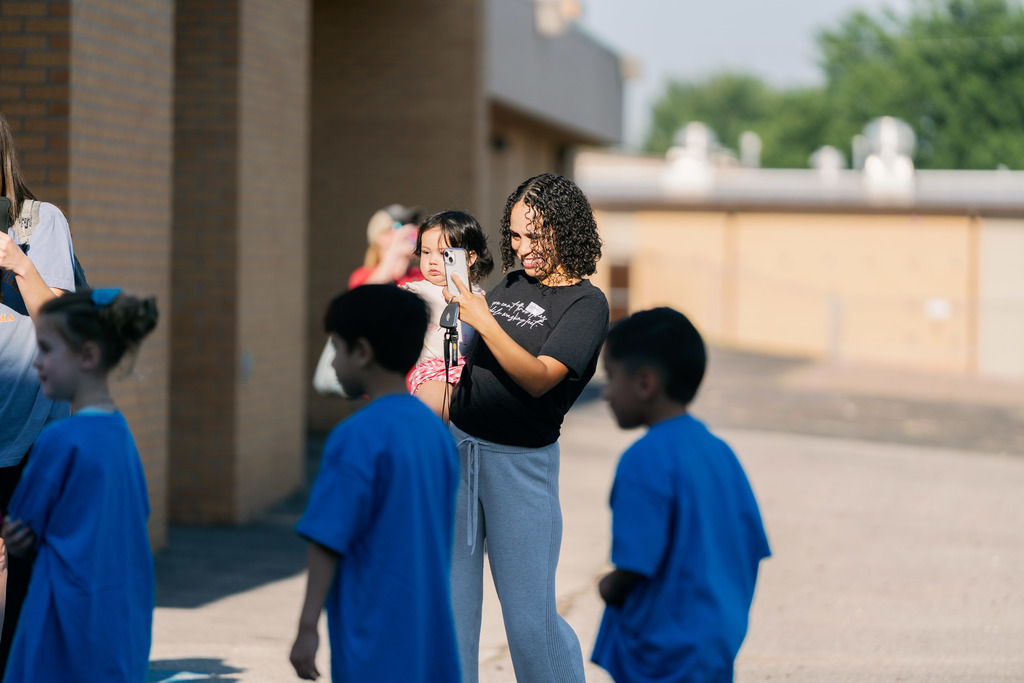 mom taking a photo of her student